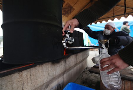 受灾者用油罐改装的简易热水器获取热水